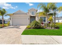 Single-story home with a two-car garage and landscaped front yard at 4309 Renwick Dr, Parrish, FL 34219