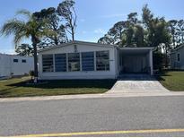 Charming single-story home with a well-manicured lawn and a covered carport at 5311 Palena Blvd, North Port, FL 34287