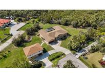 Aerial view of a well-manicured lawn and a home with a detached garage at 5694 Hale Rd, Venice, FL 34293