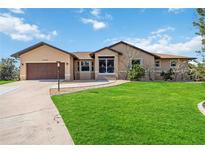 Charming single-story home features a manicured lawn and a two-car garage, enhancing curb appeal at 5694 Hale Rd, Venice, FL 34293