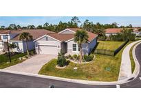 Single-story home with tile roof, landscaped yard, and driveway at 600 Nasturtium Ct, Nokomis, FL 34275