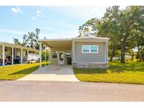 Charming single-story home featuring a covered parking area and well-maintained landscaping at 6462 Haele Ct, North Port, FL 34287