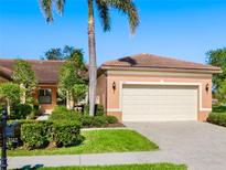Charming single-story home boasting a tile roof, manicured lawn, and a two-car garage at 1342 Maseno Dr, Venice, FL 34292