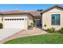 Charming single-story home featuring a two-car garage, brick driveway, and well-maintained landscaping at 1545 Maseno Dr, Venice, FL 34292