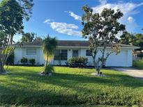 Charming single-story home with lush green lawn, manicured landscaping, and a well-maintained exterior at 181 Stanford Rd, Venice, FL 34293