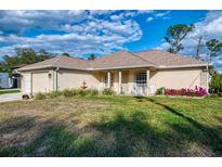 Charming single-story home with a well-manicured lawn and inviting front porch at 4332 Big Leaf St, North Port, FL 34286