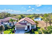 Beautiful single Gathering home with a clay tile roof and pond view at 351 Carlino Dr, Nokomis, FL 34275