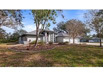 Charming single-story home with an attached three-car garage and beautifully landscaped front yard at 2537 Northway Dr, Venice, FL 34292