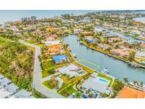 Aerial view of waterfront property with pool and circular driveway at 721 Binnacle Point Dr, Longboat Key, FL 34228