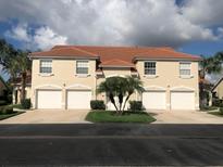 Tan three-story building with four attached garages and landscaping at 7234 Cedar Hollow Cir # 7234, Bradenton, FL 34203