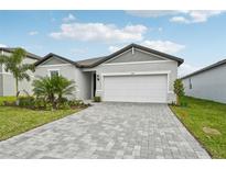 Single-story home with a paved driveway and landscaping at 494 Sun Chaser Dr, Nokomis, FL 34275