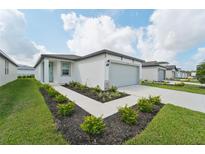 Single-story home with attached garage and landscaped front yard at 428 Lazy Shore Dr, Nokomis, FL 34275