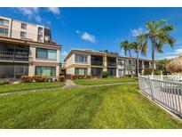 Ground level condo with balcony, showcasing a spacious layout and lush landscaping at 6268 Palma Del Mar S Blvd # 204, St Petersburg, FL 33715