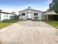 Newly renovated house with a gravel driveway and fenced yard at 1220 36Th W Ave, Bradenton, FL 34205