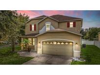 Two-story house with attached garage, evening view at 10617 Bamboo Rod Cir, Riverview, FL 33569