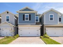 Three-unit townhome building with white garages and brick driveways at 17351 Peregrine Way, Punta Gorda, FL 33982