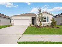 One-story home with a two-car garage and landscaped lawn at 37501 Williamette Way, Zephyrhills, FL 33540