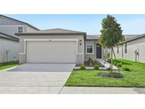 One-story home with attached garage and landscaped front yard at 444 Lazy Shore Dr, Nokomis, FL 34275