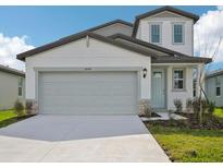 Charming two-story home with a two-car garage, light blue door, and well-maintained landscaping at 14045 Crutchfield Ct, Parrish, FL 34219