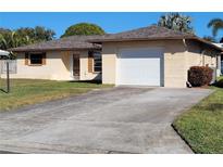 Ranch style home with attached garage and driveway at 2587 Blackwood Cir, Clearwater, FL 33763