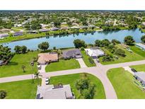 Aerial view of waterfront home with large lot and canal access at 7384 Van Lake Dr, Englewood, FL 34224