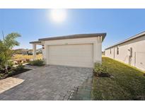 New home with attached garage and paved driveway at 120 Whiteland Bnd, Nokomis, FL 34275