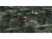 Aerial view showing a single-story house with a pool in a residential neighborhood at 4935 Mockingbird Dr, Dade City, FL 33523