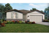 One-story home with landscaped yard, attached garage, and stone accents at 31647 Malbec Dr, Brooksville, FL 34602