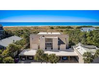 Aerial view of condo showing oceanfront location, parking, and building features at 524 Beach Rd # A, Sarasota, FL 34242