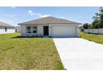 One-story house with attached garage and a well-maintained lawn at 22162 Seaton Ave, Port Charlotte, FL 33954