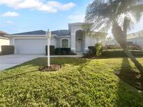 Single-story home with a two-car garage and manicured lawn at 7431 39Th E Ct, Sarasota, FL 34243