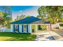 Charming light green house with a newly landscaped lawn and walkway at 2246 Goldenrod St, Sarasota, FL 34239