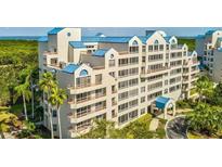 Multi-story building with blue roofs and waterfront views at 2333 Feather Sound Dr # A101, Clearwater, FL 33762