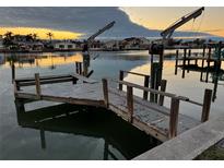 Rustic wooden boat dock with lift, offering convenient water access at 11240 6Th E St, Treasure Island, FL 33706