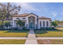 Beautiful home with a modern design, landscaped lawn, and walkway at 988 47Th N Ave, St Petersburg, FL 33703