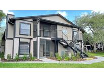 Two-story building with screened porch and landscaping at 4034 Dream Oak Pl # 104, Tampa, FL 33613