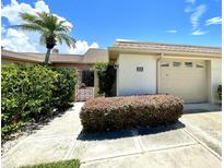 Inviting exterior with well-manicured landscaping and a two-car garage at 514 Boca Ciega Point N Blvd, St Petersburg, FL 33708