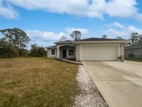 Newly built home with a two-car garage and spacious lawn at 4782 Lummus St, North Port, FL 34286