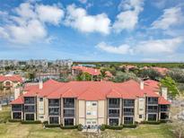 Aerial view of an apartment building with red tile roofs and balconies at 2400 Feather Sound Dr # 613, Clearwater, FL 33762