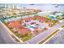 Aerial view of waterfront community with pool and boat slips at 2600 N Paula Dr # 19A, Dunedin, FL 34698