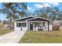 Charming remodeled home with a modern black and white exterior, and a spacious front yard at 1898 New Hampshire Ne Ave, St Petersburg, FL 33703