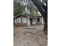 Tan house with small deck and yard at 3409 E 9Th Ave, Tampa, FL 33605