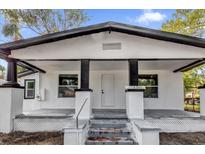 White house with black accents, front porch, and steps at 3206 N 29Th St, Tampa, FL 33605
