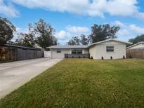 Updated single story home with a well-manicured lawn and driveway at 5339 Brookmeade Dr, Sarasota, FL 34232