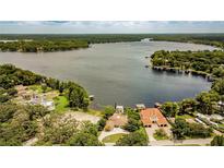 Stunning lakefront property featuring lush landscaping and incredible water views at 18129 Crawley Rd, Odessa, FL 33556