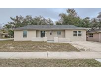 Charming single-story home with a well-maintained lawn and driveway at 11606 Nature Trl, Port Richey, FL 34668