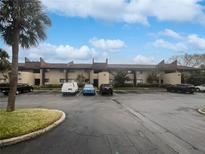 Condo building exterior with parking and landscaping at 705 S Village N Dr # 205, St Petersburg, FL 33716