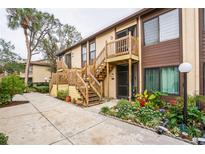 Condo building exterior with wood stairs and landscaping at 5711 Avista Dr # 4110, Sarasota, FL 34243