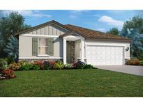 One-story home with a two-car garage, landscaping, and stone accents at 1875 Draughton Dr, Zephyrhills, FL 33541