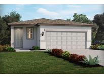 One-story home with two-car garage and landscaped front yard at 1876 Brekey Way, Zephyrhills, FL 33541